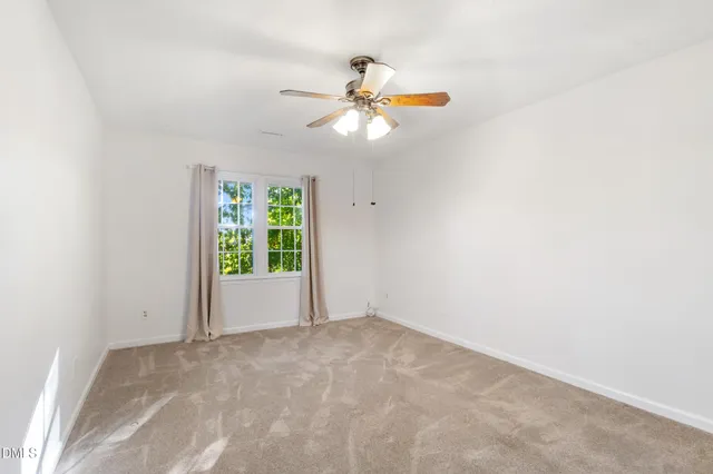 an aerial view of a house with a yard and lake view