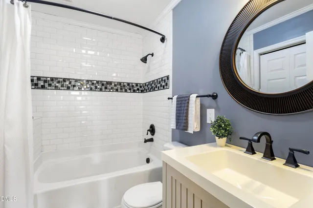 an aerial view of residential houses with outdoor space and trees