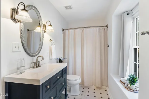 a bathroom with a sink and a window