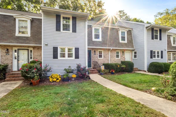 a group of people sitting in front of a house