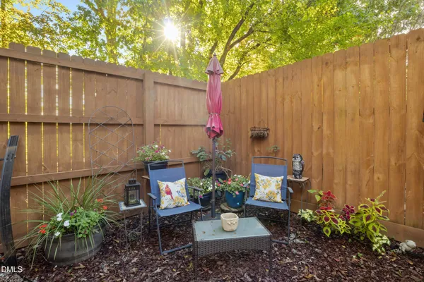 a view of a porch with wooden floor and a swing