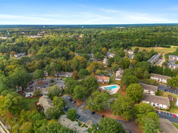 an aerial view of a house with a yard and lake view