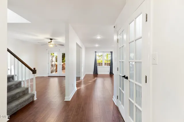a view of wooden floor and windows in a room
