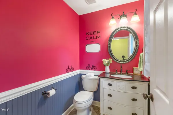 a bathroom with a toilet a sink and a mirror