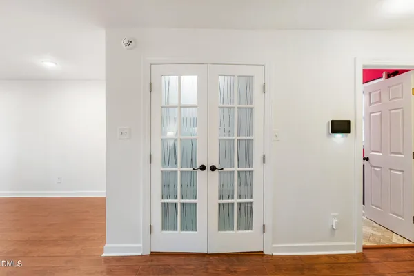 a view of wooden floor and windows in a room