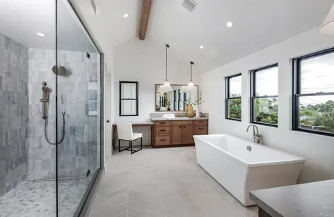 a bathroom with a double vanity sink mirror and shower