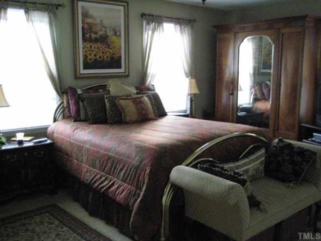 518 Andover Road Durham, NC 27712 - Photo 6 of 9 a bedroom with a bed and wooden floor