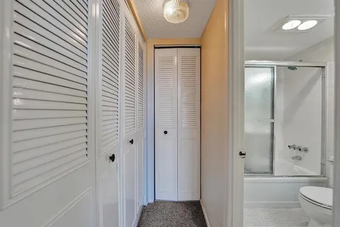 a bathroom with a sink toilet a mirror and shower