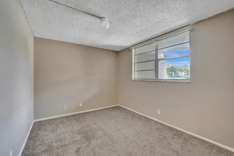 a view of a house with pool and sitting area