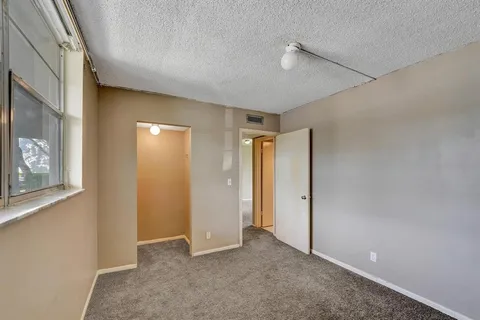 a view of a hallway with seating area
