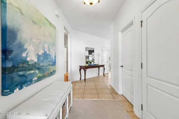 a kitchen with granite countertop a sink a stove top oven and refrigerator