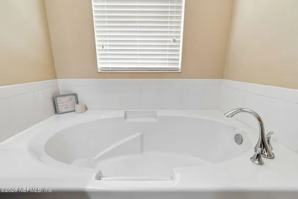 a bedroom with a bed a table and chair