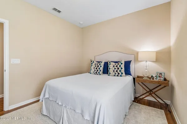 a bathroom with a double vanity sink a large mirror and a bathtub
