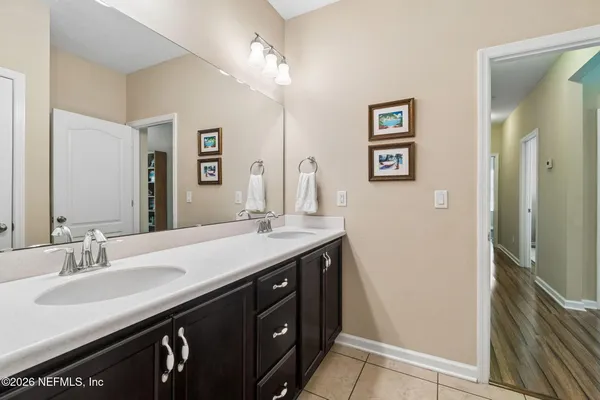 a bedroom with a bed a mirror and a window