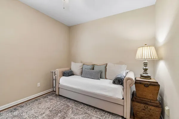 a bedroom with furniture and a book shelf