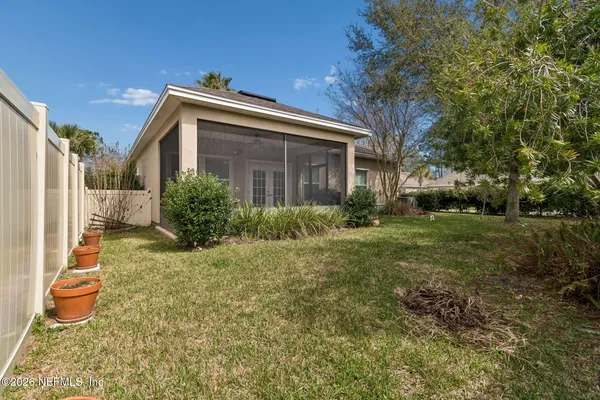 a view of a house with a yard and palm trees
