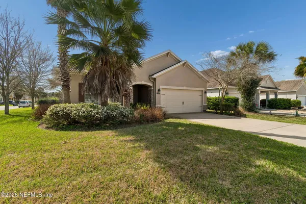 an aerial view of a house with a yard and lake view