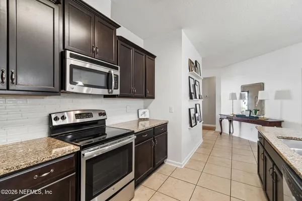 a view of a kitchen with granite countertop cabinets