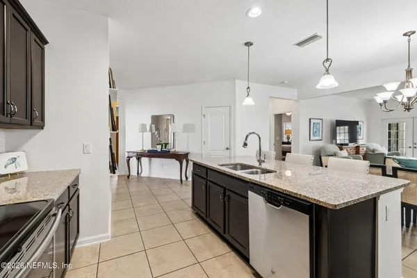a kitchen with granite countertop kitchen island cabinets and appliances
