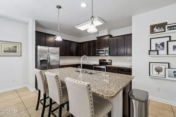 a view of a dining room with furniture and a chandelier