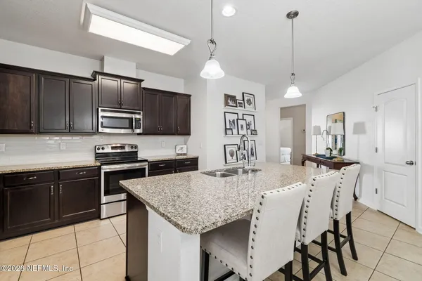 a view of a dining room with furniture and chandelier