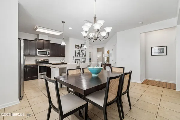 a view of a dining room with furniture and chandelier