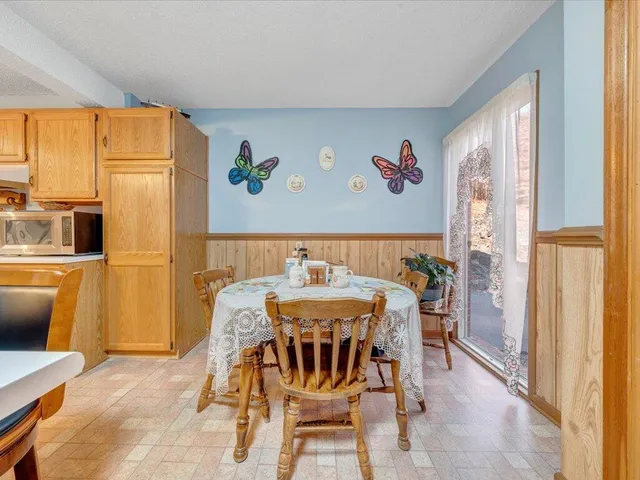 a view of a dining room with furniture window and outside view
