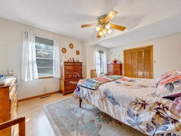 a bedroom with a bed and a chandelier