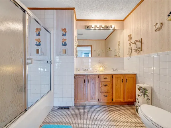 a view of a patio with table and chairs and a large tree