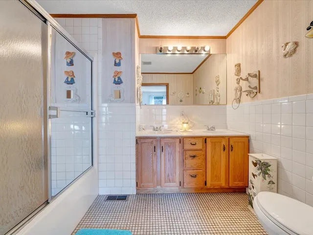 a view of a patio with table and chairs and a large tree