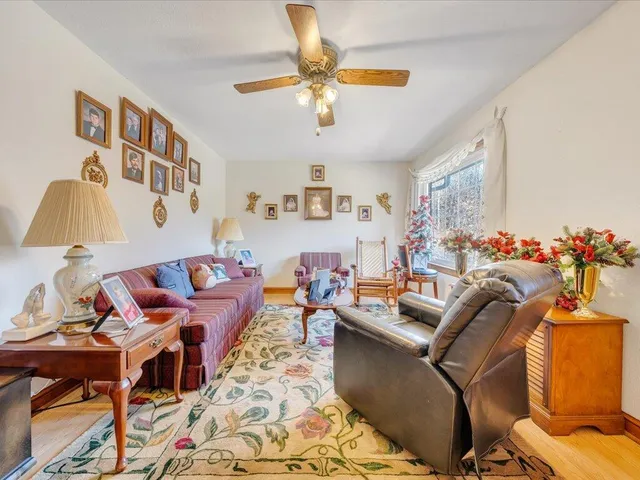 a living room with furniture and a chandelier