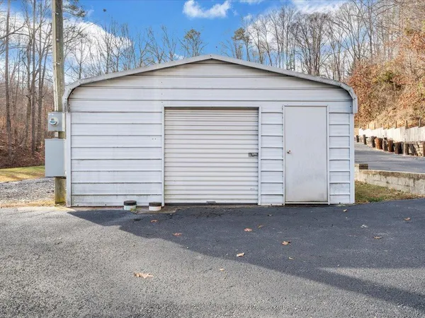 a view of a house with swimming pool and sitting area