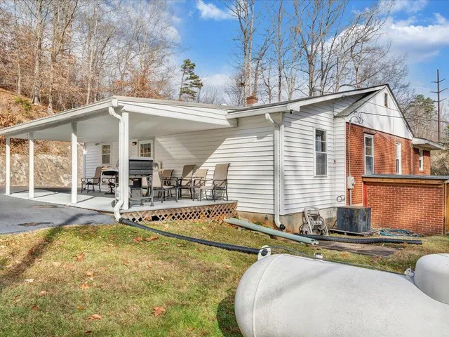 a view of a house with pool and chairs