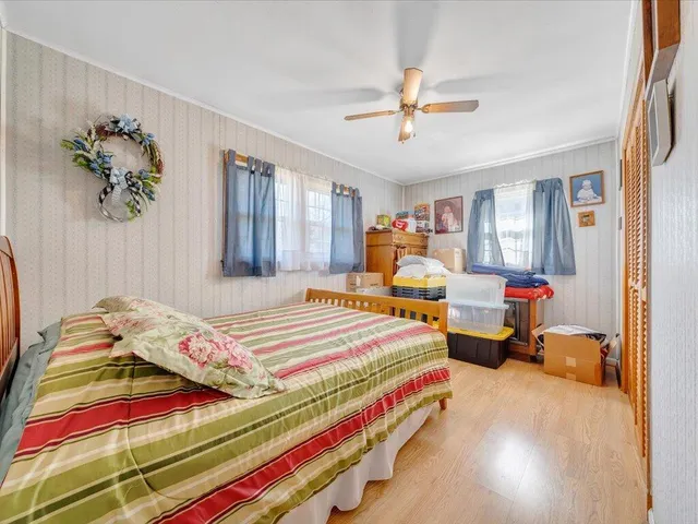 a bedroom with bed and window