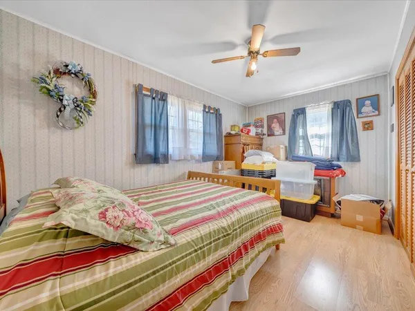 a bedroom with a bed and a chandelier