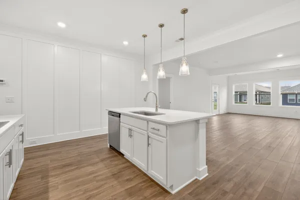 a spacious kitchen with a sink and cabinets