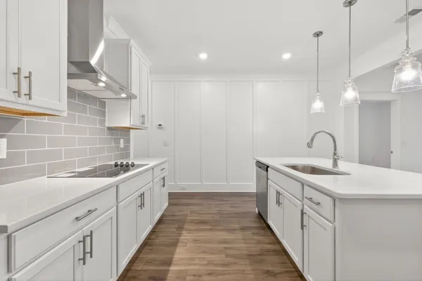 a kitchen with kitchen island a stove a sink a center island and cabinets