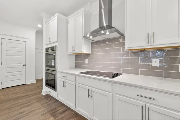 a kitchen with stainless steel appliances a sink stove and cabinets