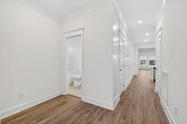 a view of empty room with wooden floor