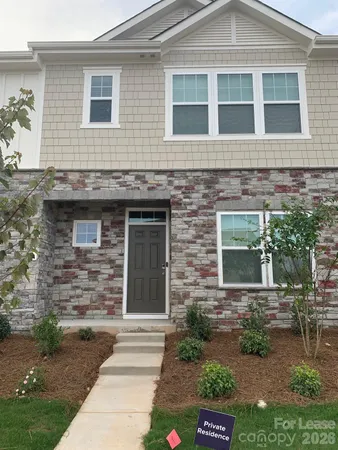 a view of a brick house with a yard