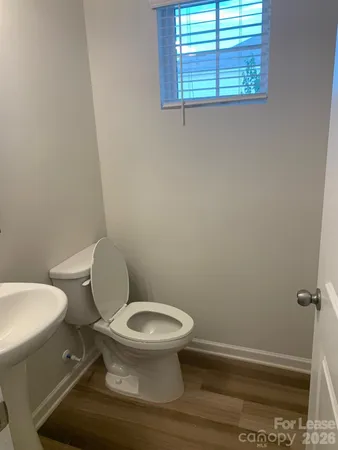 a white toilet sitting next to a window