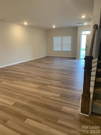 a view of a room with wooden floor and chair