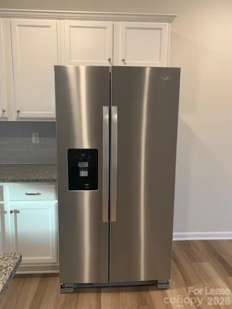 a refrigerator freezer sitting inside of a kitchen