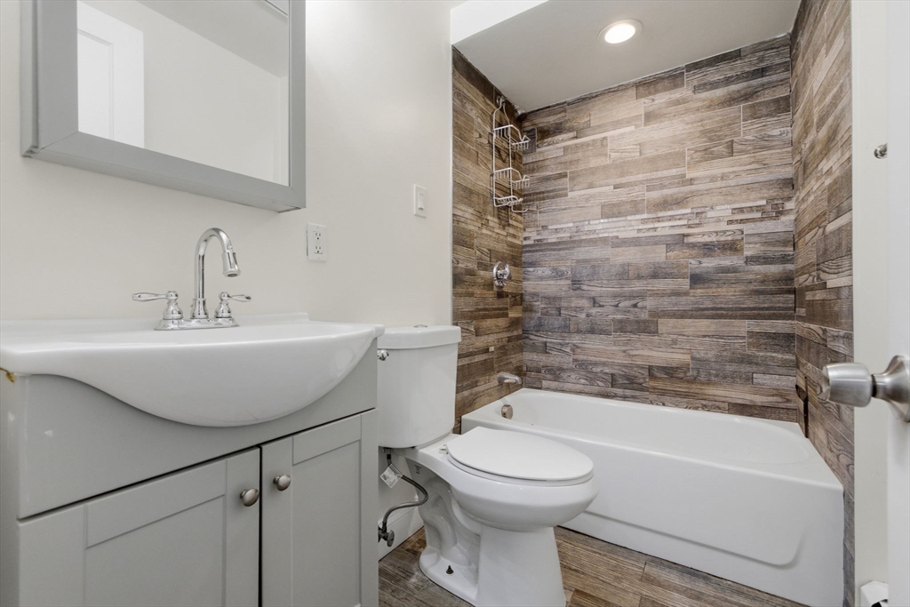 60 Tudor Street, Unit 1 Lynn, MA 01902 - Photo 15 of 19 a bathroom with a sink toilet and shower
