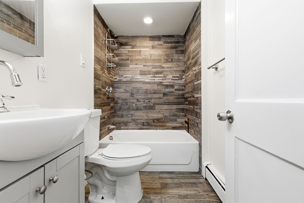 60 Tudor Street, Unit 1 Lynn, MA 01902 - Photo 16 of 19 a bathroom with a toilet and a bathtub