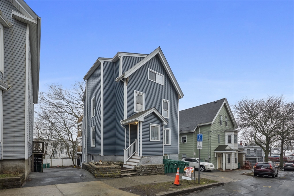 60 Tudor Street, Unit 1 Lynn, MA 01902 - Photo 2 of 19 a front view of a house with a street