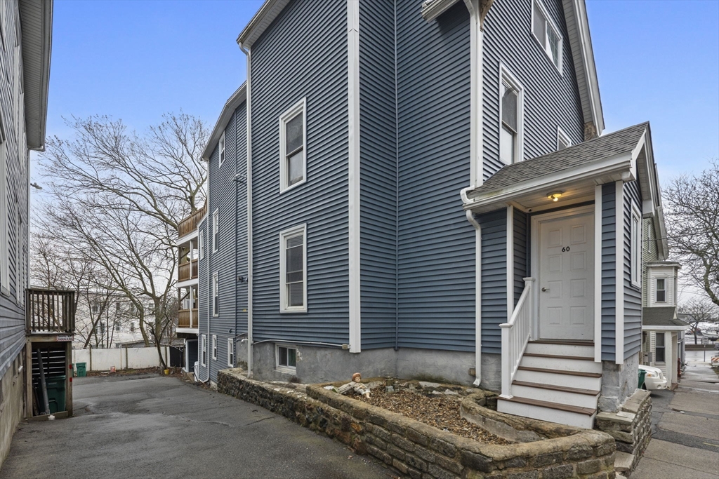 60 Tudor Street, Unit 1 Lynn, MA 01902 - Photo 3 of 19 a front view of a house with a tree