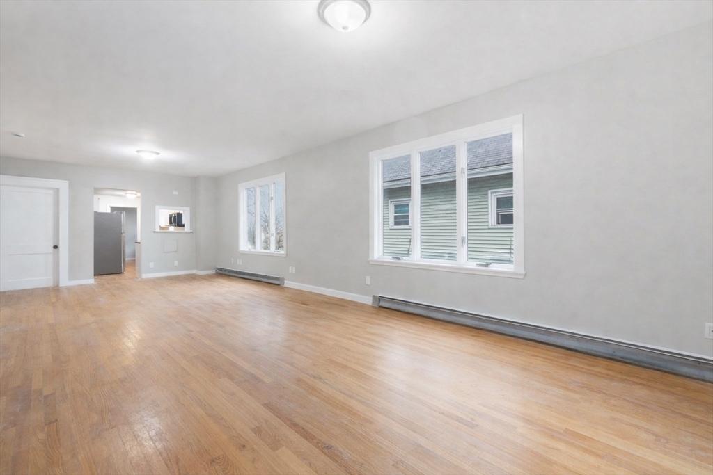 60 Tudor Street, Unit 1 Lynn, MA 01902 - Photo 9 of 19 a view of empty room with wooden floor and fan