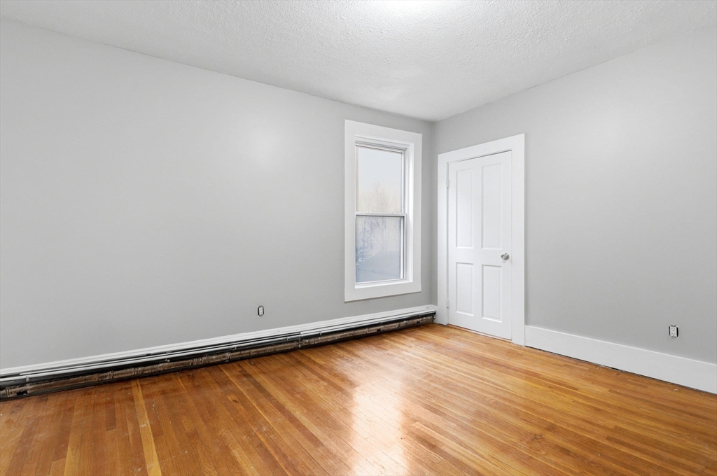 60 Tudor Street, Unit 1 Lynn, MA 01902 - Photo 10 of 19 a view of room with window and wooden floor