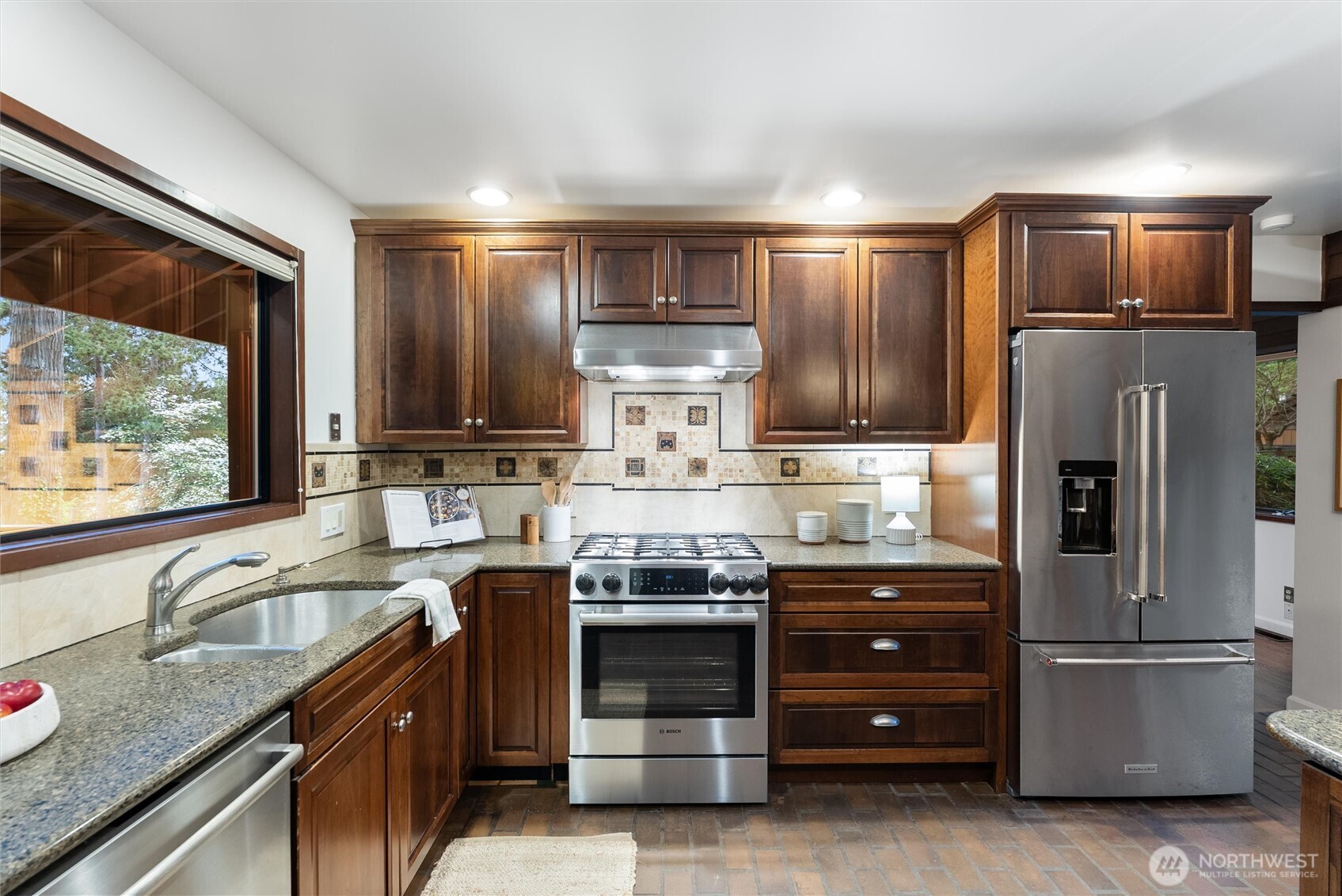 6920 160th Street Southwest Edmonds, WA 98026 - Photo 16 of 40 a kitchen with granite countertop stainless steel appliances and wooden cabinets